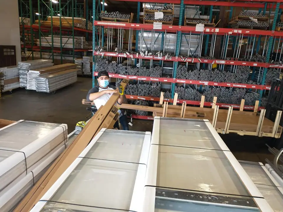 American Garage Door Solution technicians preparing garage door materials for a Missouri City-area installation