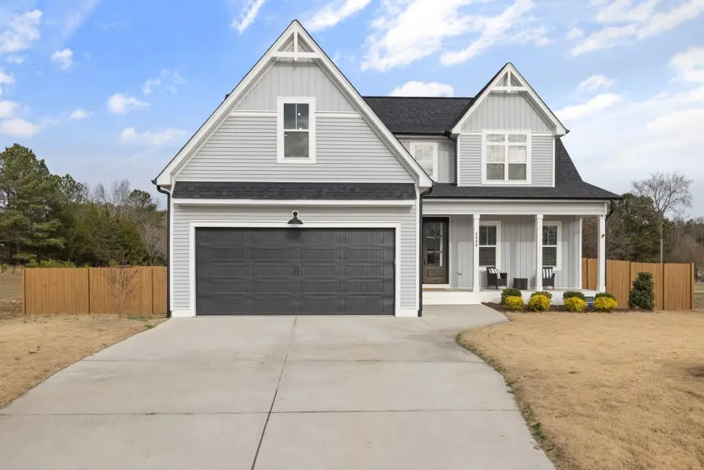 Modern suburban two story home with garage in sunny weather