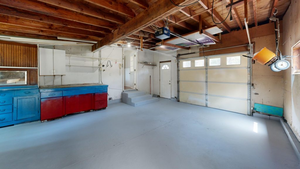 Spacious wooden garage interior with blue and red cabinets